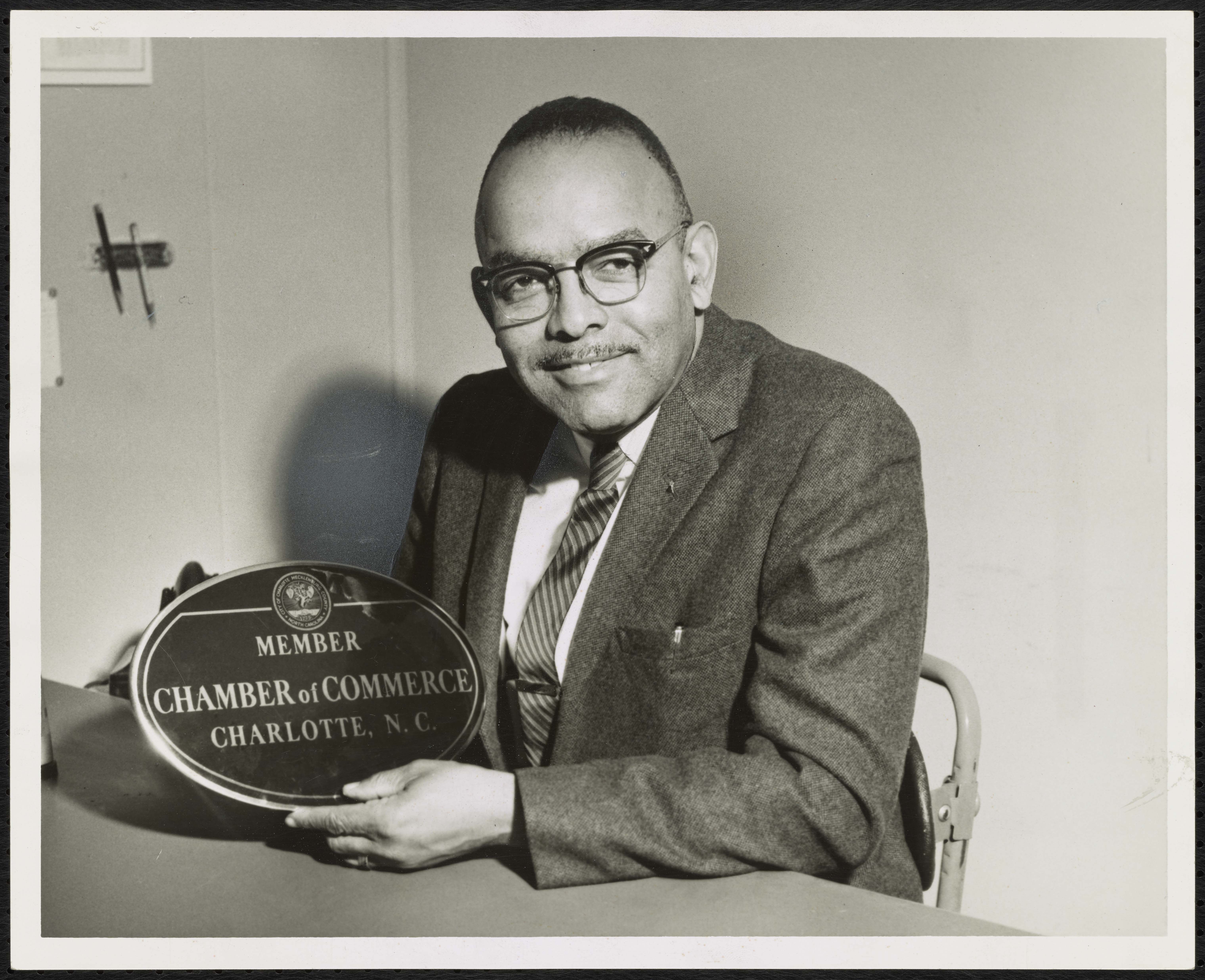 Fred Alexander holding an award from the Chamber of Commerce