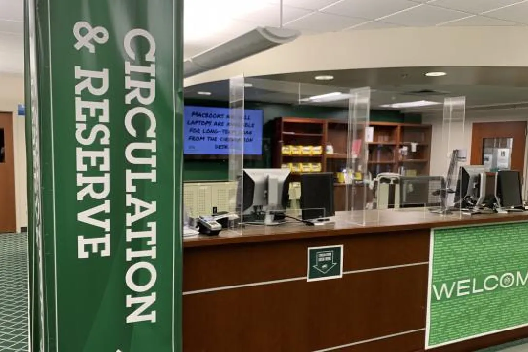 Image of the circulation desk with plexiglass guards installed